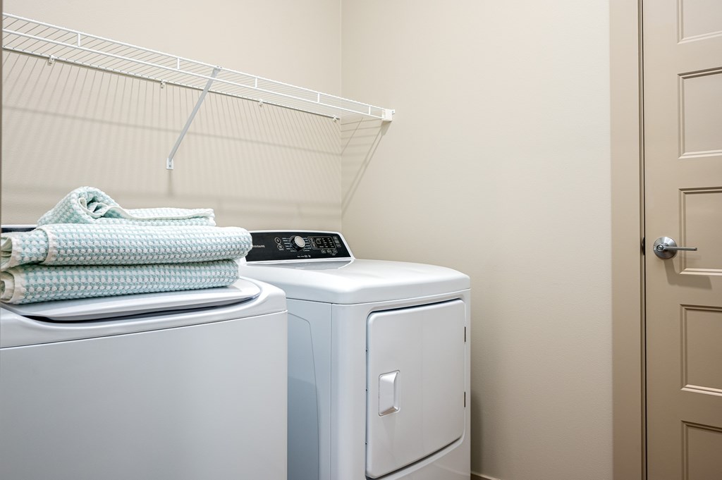 A white dryer is next to a white washing machine.