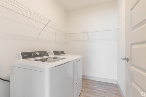 an empty laundry room with a washer and dryer in it