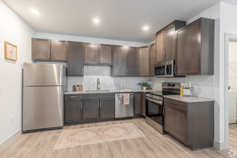 a kitchen with stainless steel appliances and wooden cabinets