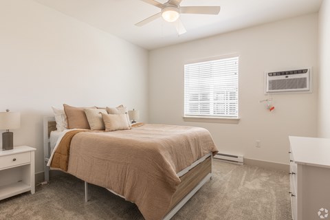a bedroom with a bed and a ceiling fan
