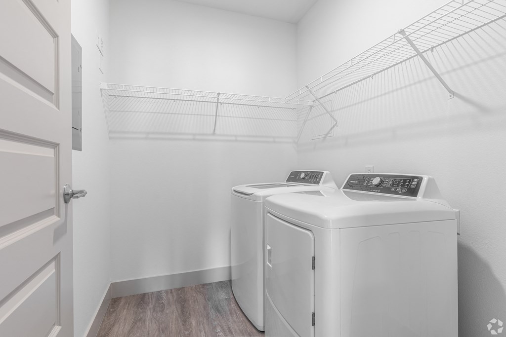 the laundry room has two washes and a dryer in it