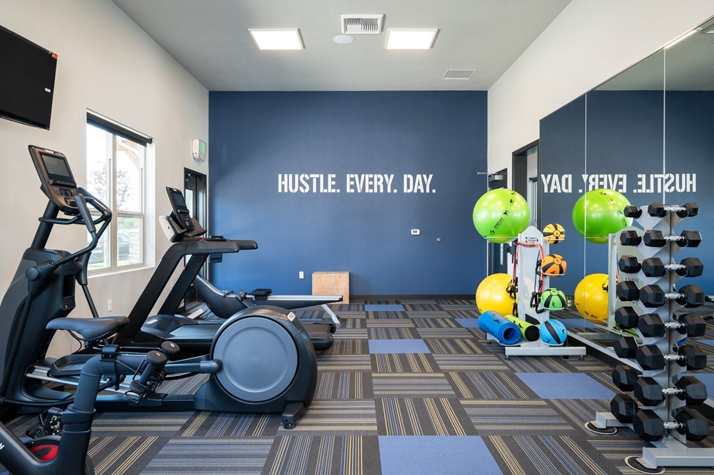 a gym with cardio equipment and weights