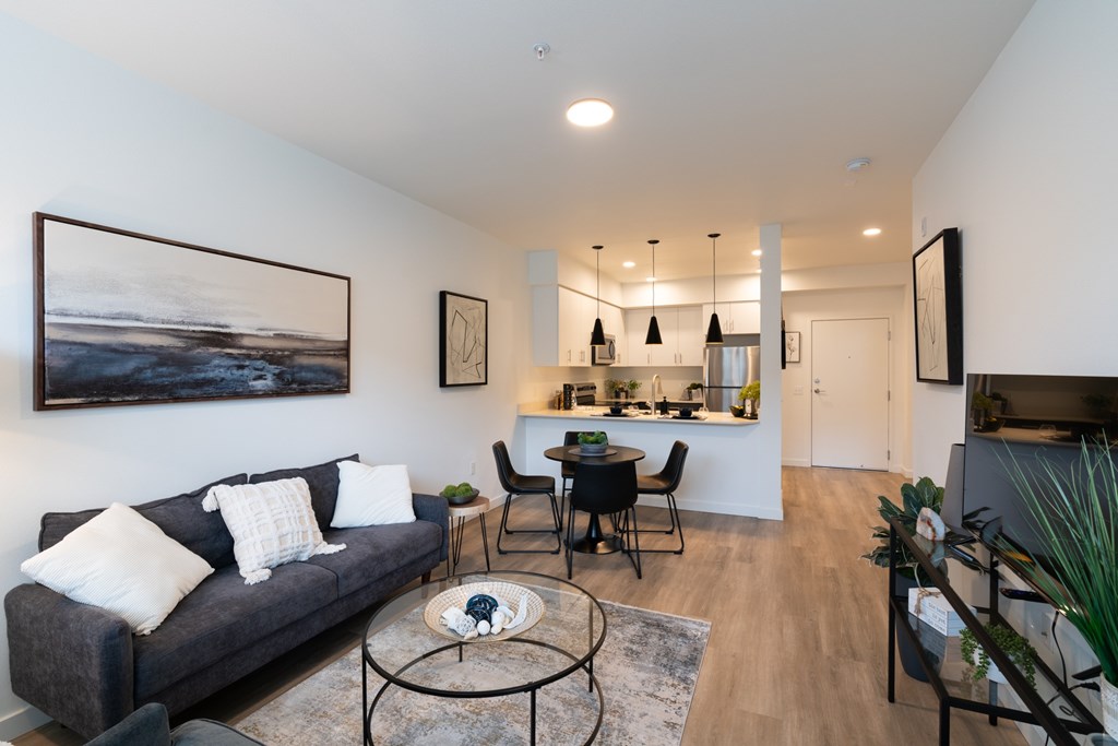 A living room with a grey couch and a coffee table.