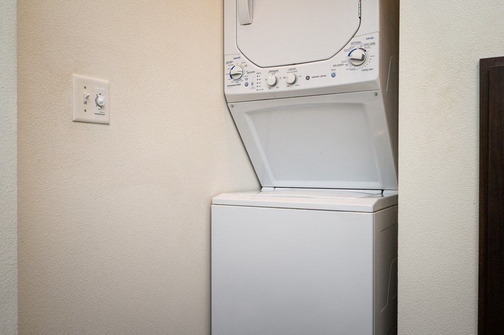 a washer and dryer in a room next to a wall