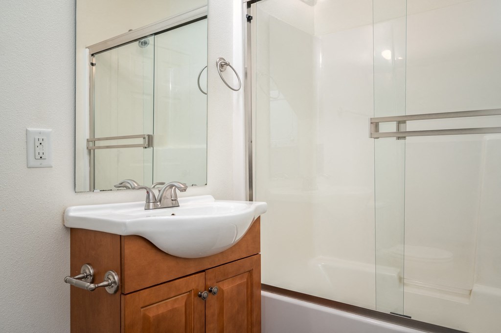 a small bathroom with a sink and a shower