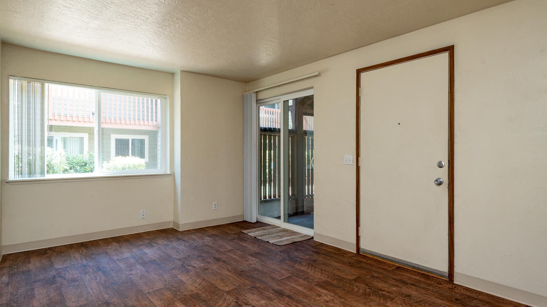 Broadway Center | Spacious Living and Dining Rooms with Plank Like Flooring