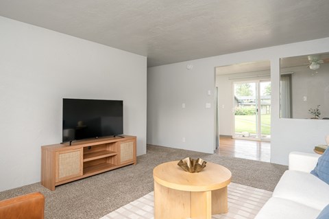 A living room with a television and a coffee table.