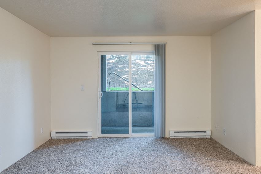 an empty room with a door to a patio