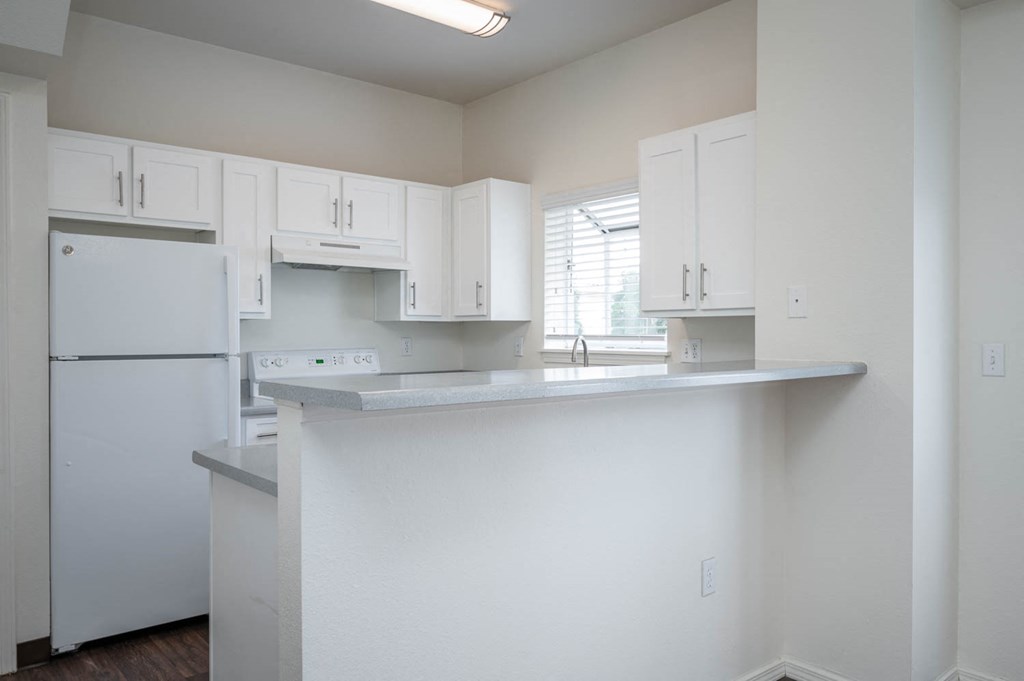 Village at Main Street | 2x2 Kitchen with White Cabinetry and Appliance and Eat In Counter