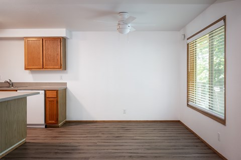 A kitchen with wooden cabinets and a white dishwasher.