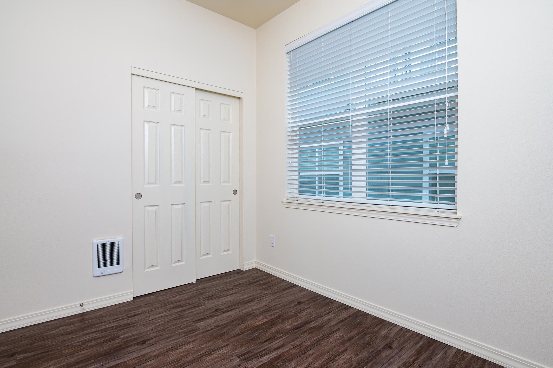 Bedroom with large closet and window.