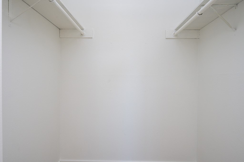 A white wall with two white bars on top.
