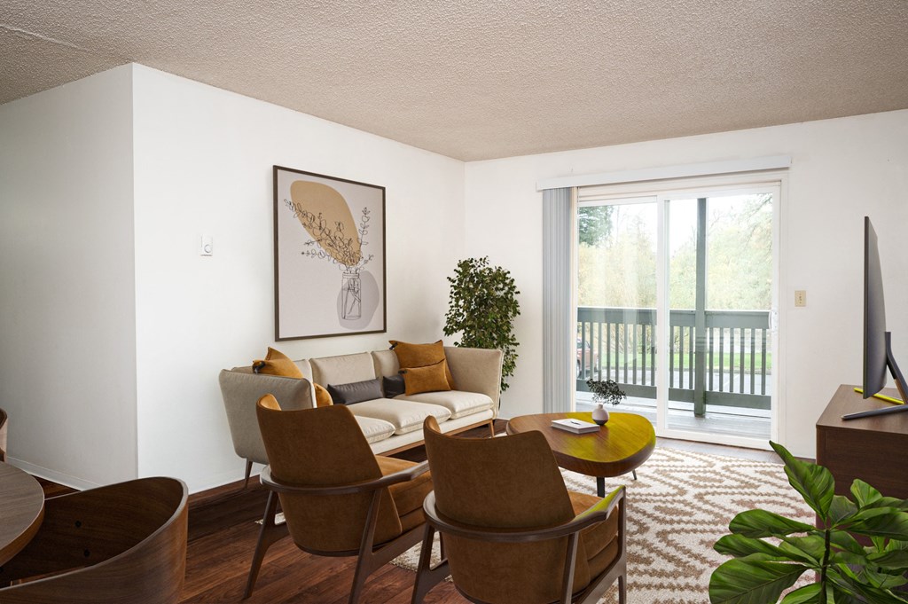 A living room with a brown chair and a brown couch.