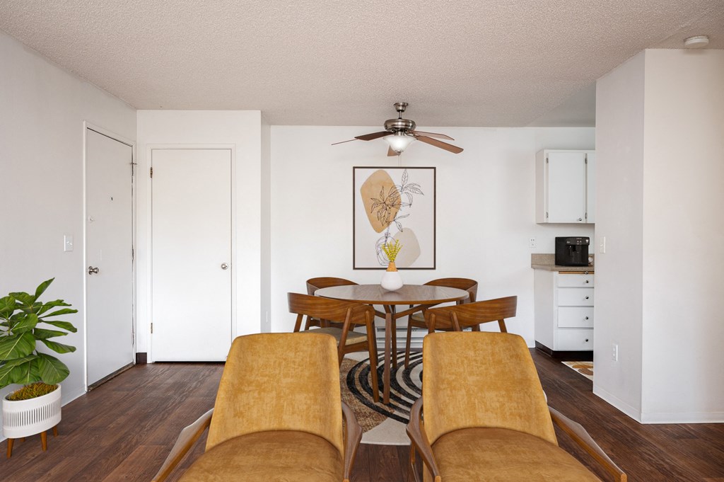 A dining room with a wooden table and chairs.