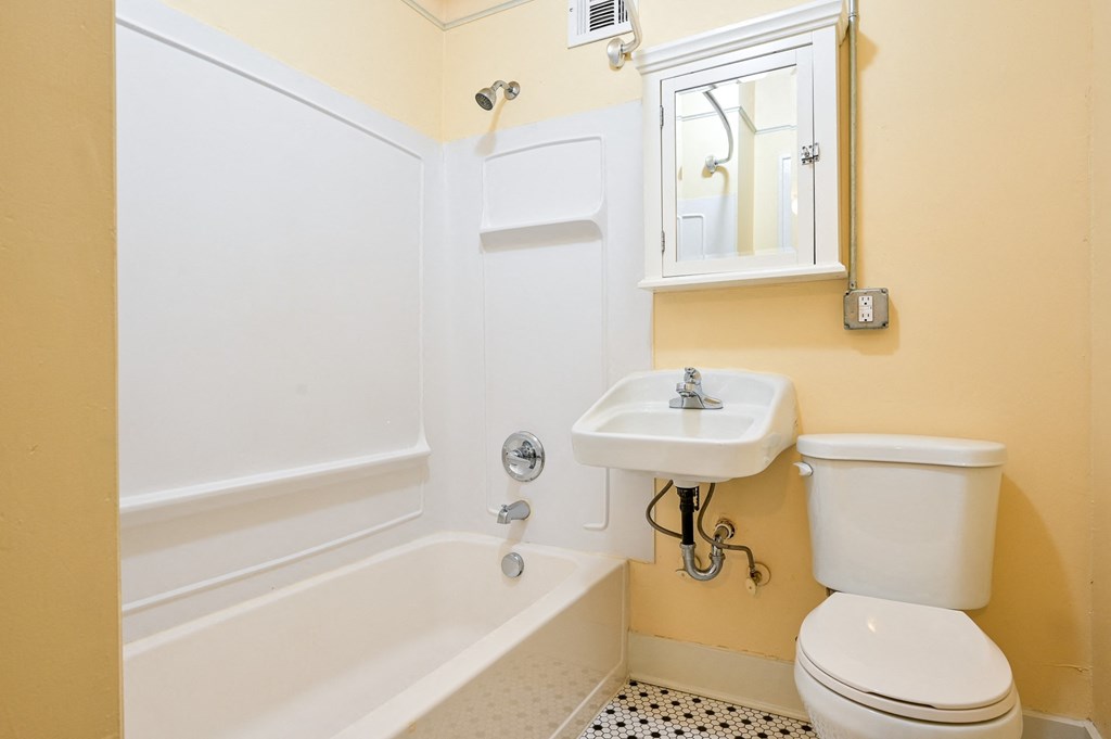a bathroom with a toilet sink and bathtub
