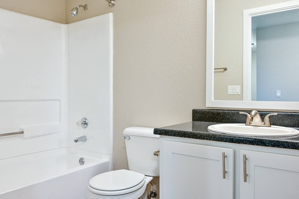 a bathroom with a sink toilet and a bath tub