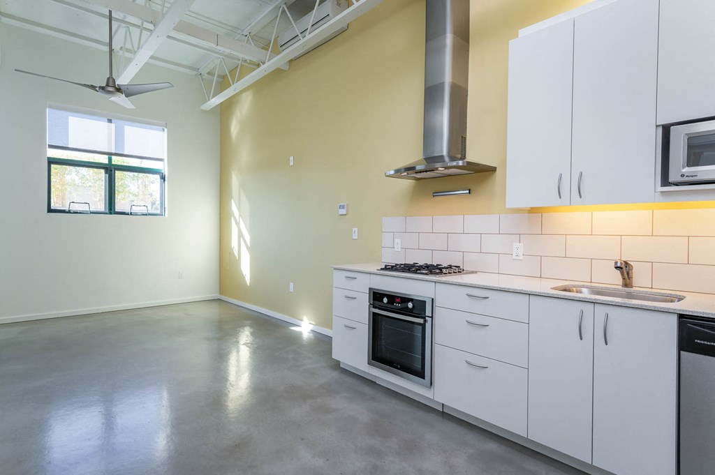 a kitchen with white cabinets and a stove