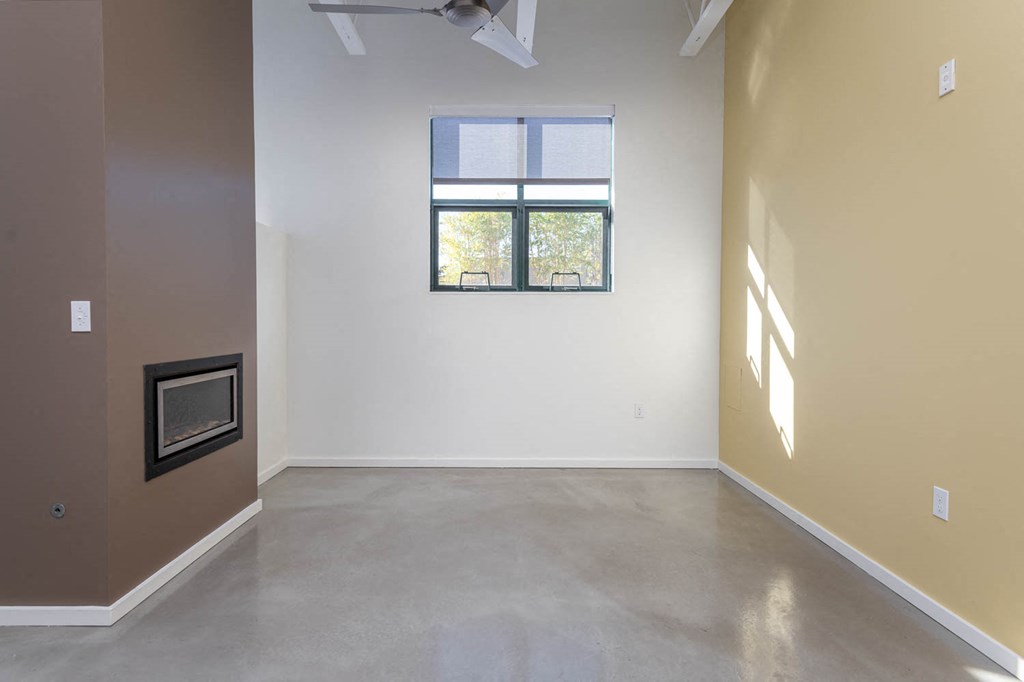 a living room with a fireplace and a window