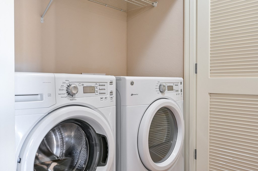 two washers and dryers in a laundry room