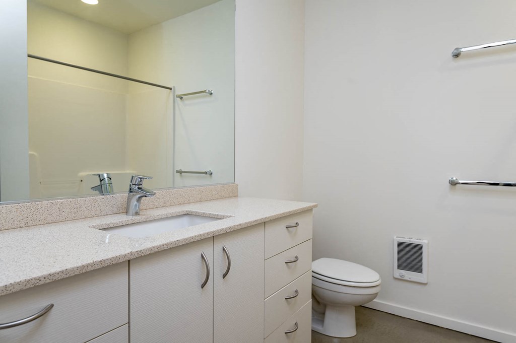 a bathroom with a sink toilet and a mirror