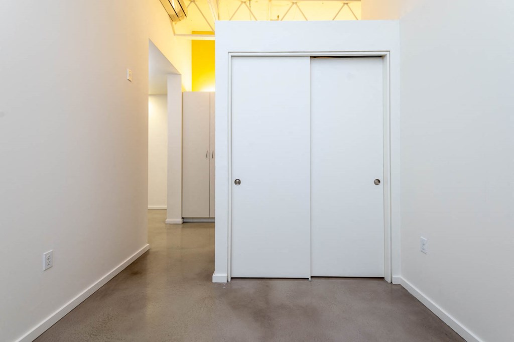 a room with white walls and white doors