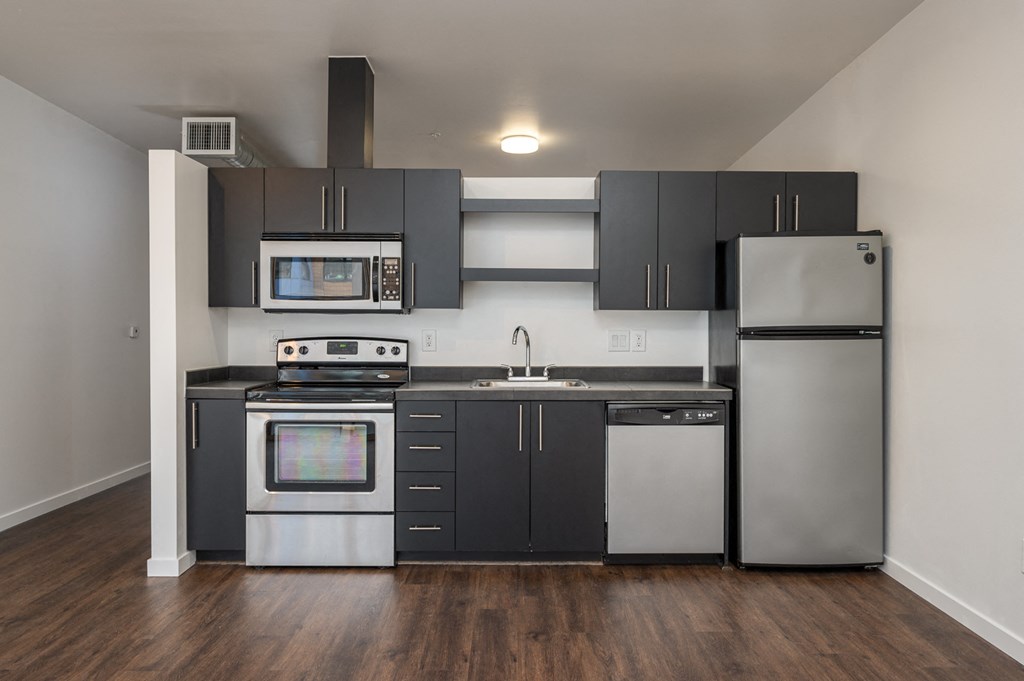 a kitchen with stainless steel appliances and black and white cabinets