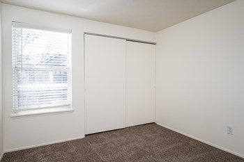 a bedroom with white walls and a window with blinds - Photo Gallery 22