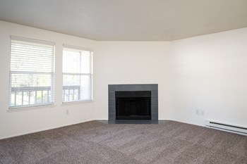 a living room with a fireplace and two windows - Photo Gallery 18