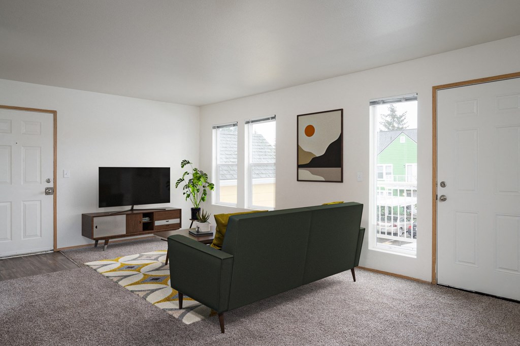 a living room with a green couch and a television