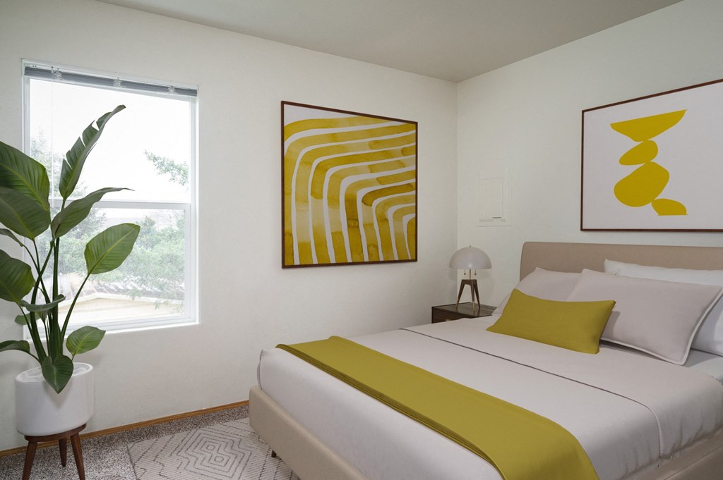 a bedroom with a white bed and a yellow blanket