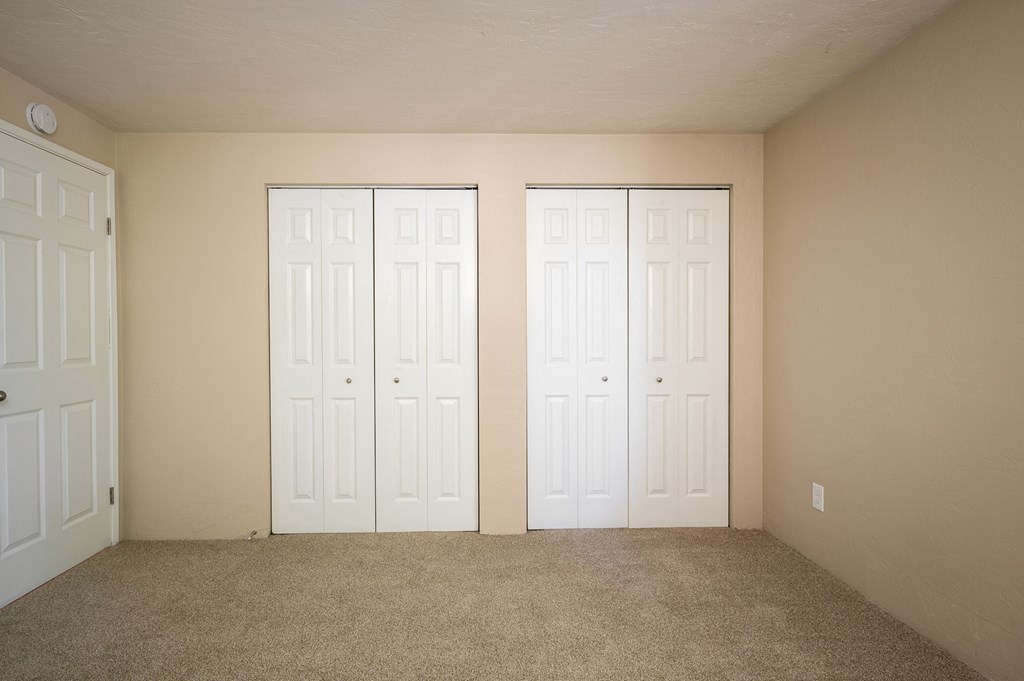 an empty room with two white doors