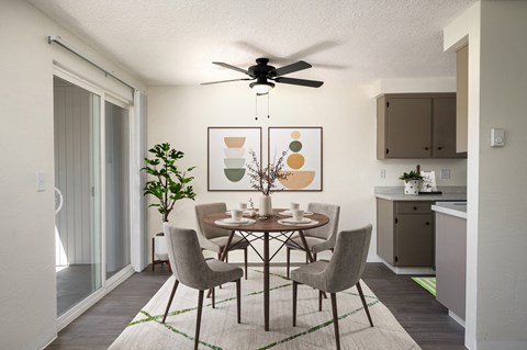 A dining room with a table set for four.