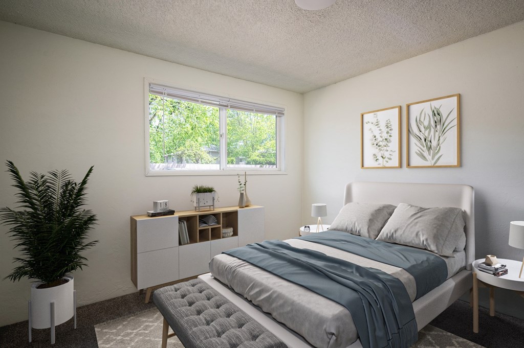 A bedroom with a bed, nightstand, and a plant.