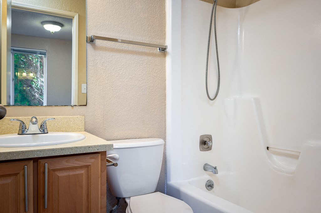 a bathroom with a toilet sink and shower