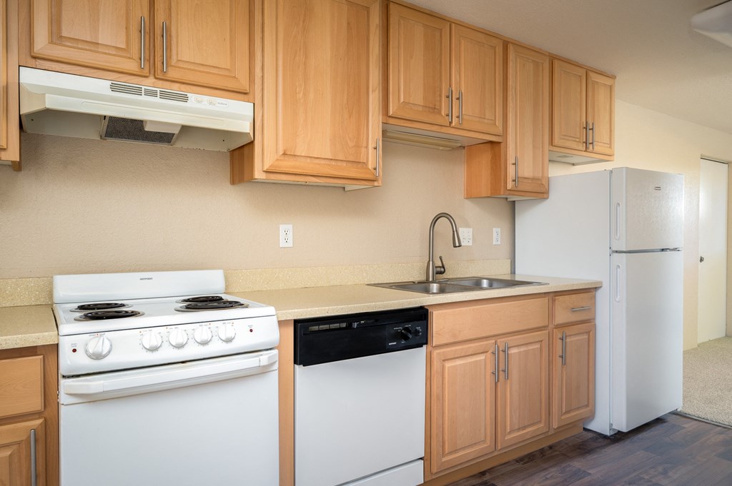 a kitchen with counters with different colored refrigerator doors