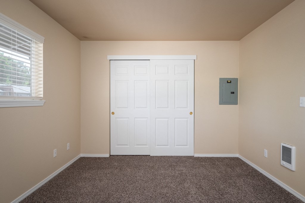 an empty room with carpet and a white door