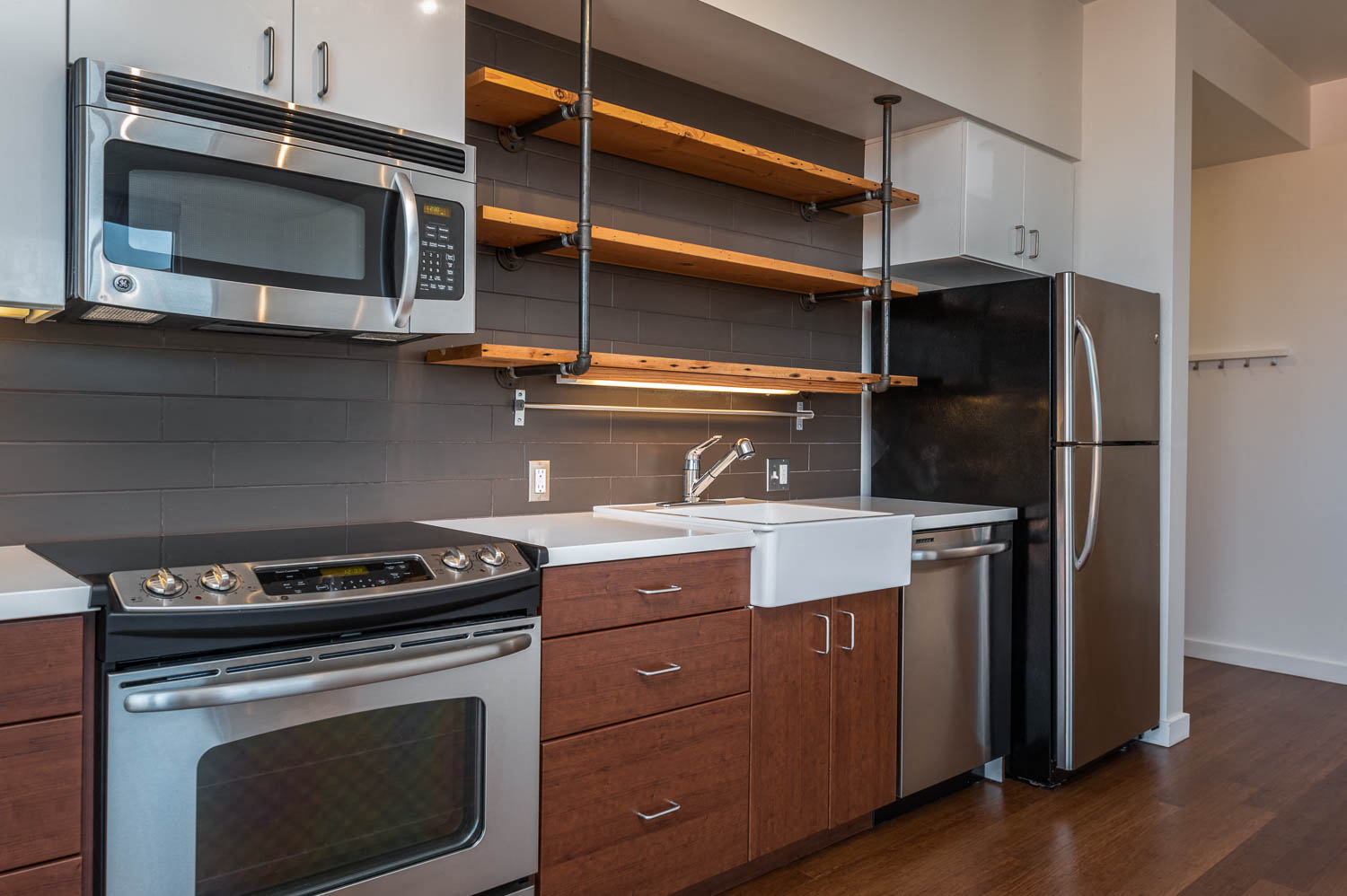 a kitchen with stainless steel appliances and wooden cabinets