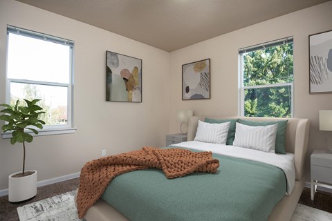 a bedroom with a bed and two windows