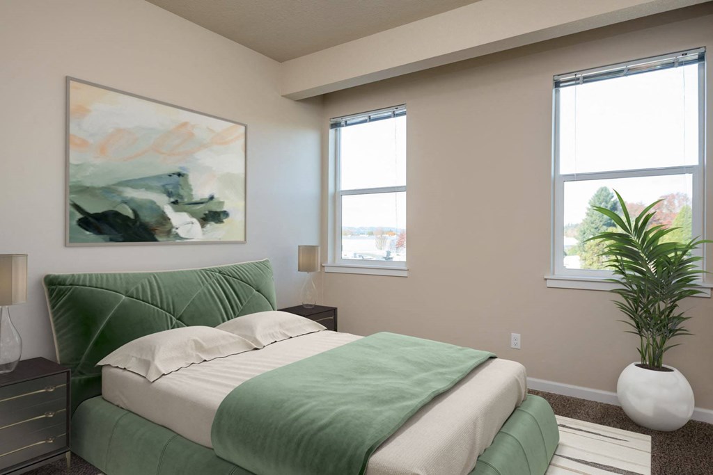 a bedroom with a green bed and two windows