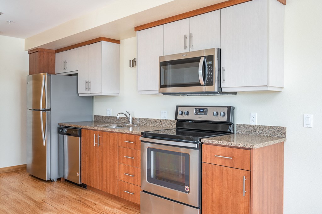 a kitchen with stainless steel appliances and white cabinets