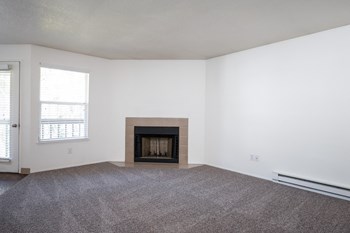 a living room with a fireplace and white walls