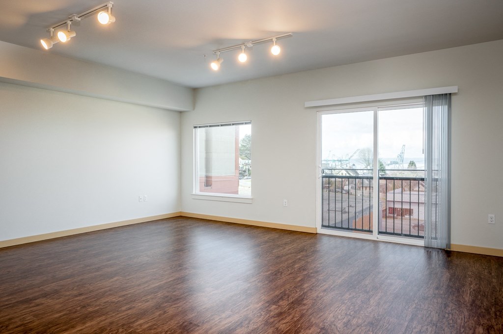 living room with wood flooring and sliding glass doors to balcony
