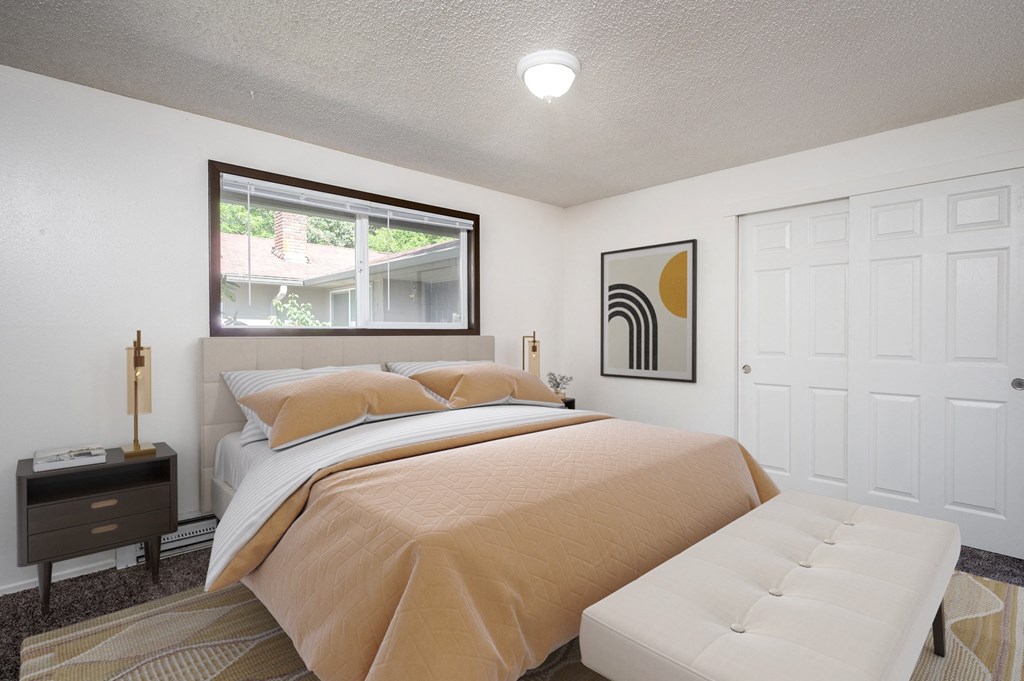 a bedroom with a bed and a window