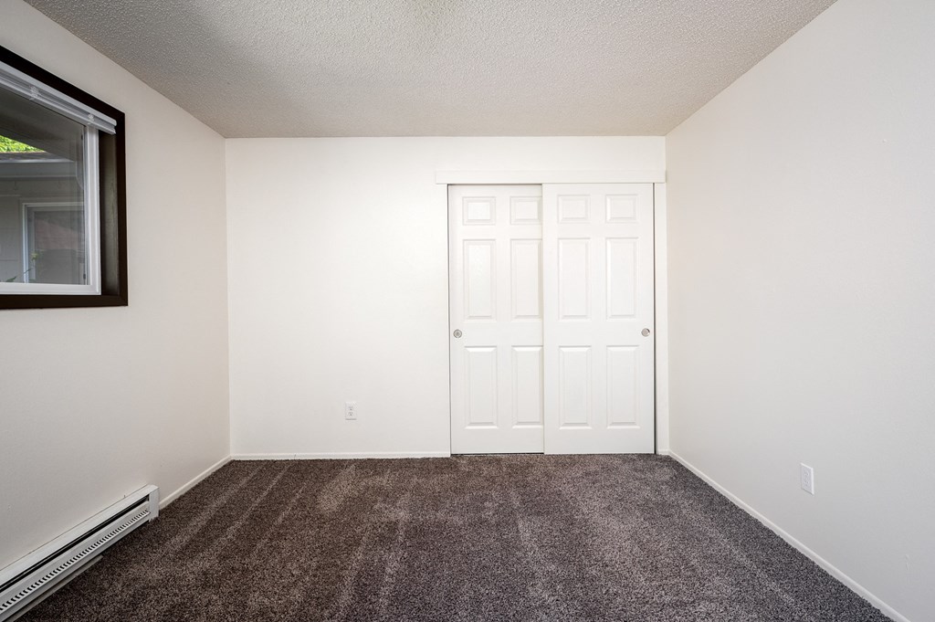an empty room with carpet and a door