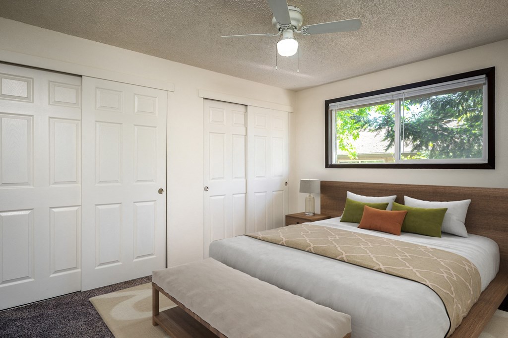 a bedroom with a bed and a window