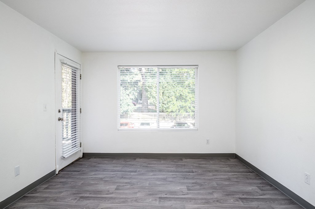 an empty room with white walls and a window