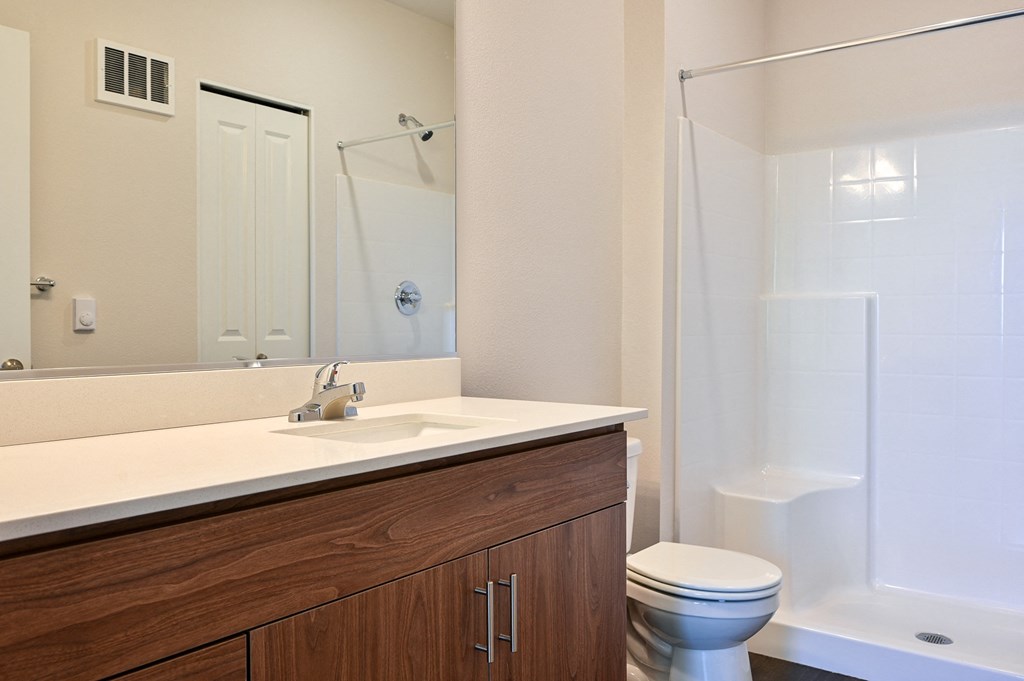 a bathroom with a toilet sink and shower