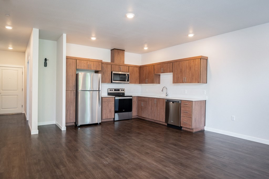 a kitchen with wooden cabinets and stainless steel appliances