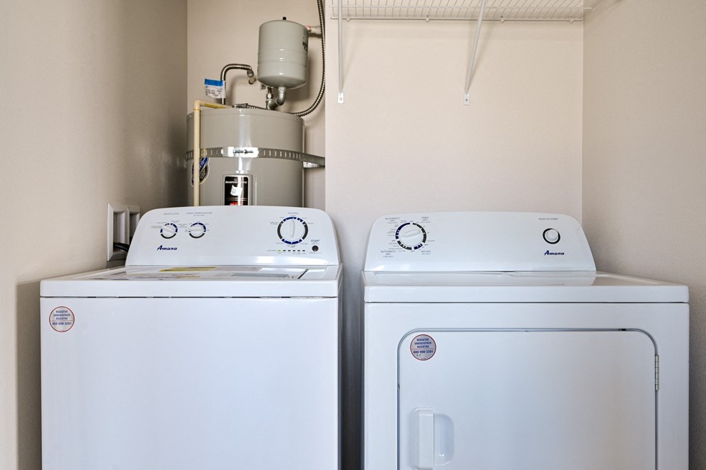 a washer and dryer sit next to each other in a laundry room