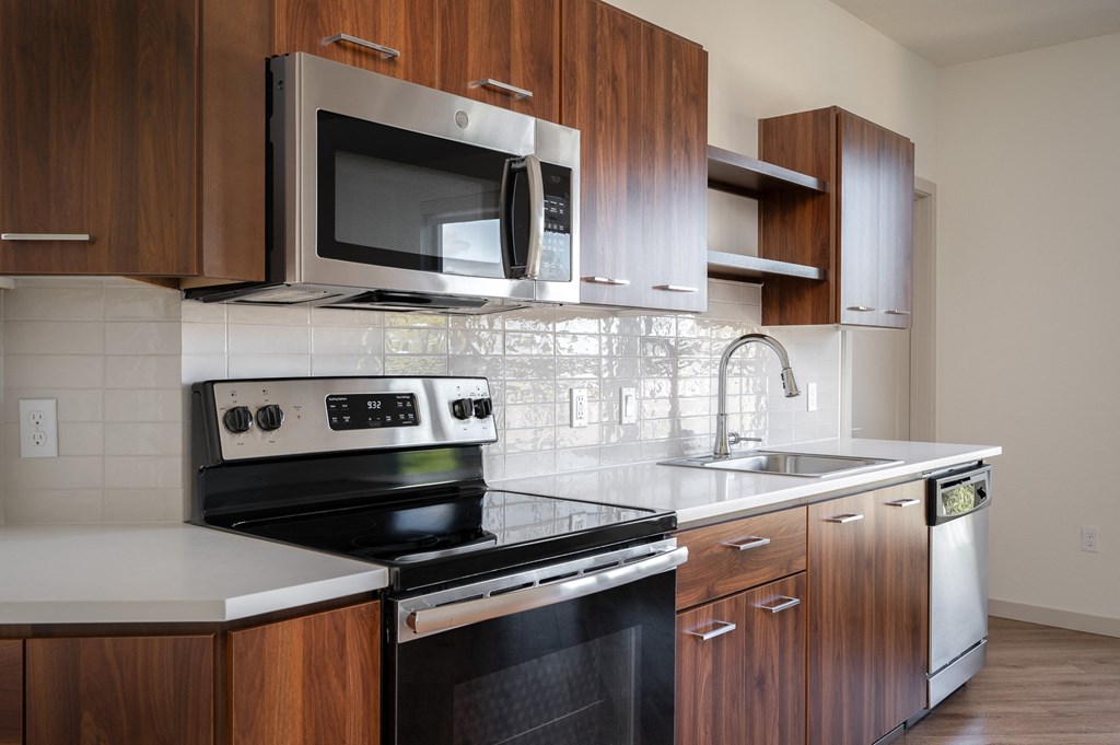 a kitchen with a stove microwave and sink